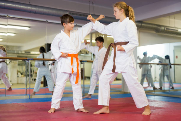 istock Karate kids training in gym 1353282267