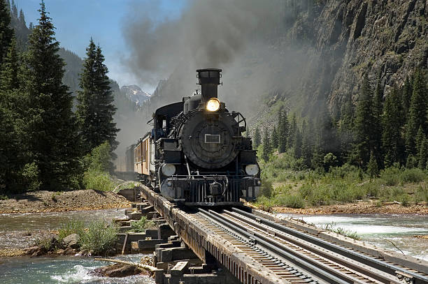 Narrow Gauge Train River Crossing Narrow gauge steam powered train crosses the Animus River on its way to Silverton from Durango, Colorado. locomotive photos stock pictures, royalty-free photos & images