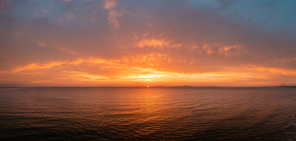 Sky into flames, an amazing panoramic photo of a sunset over Ionian Sea, at Kourouta Beach in Ilia, Amaliada