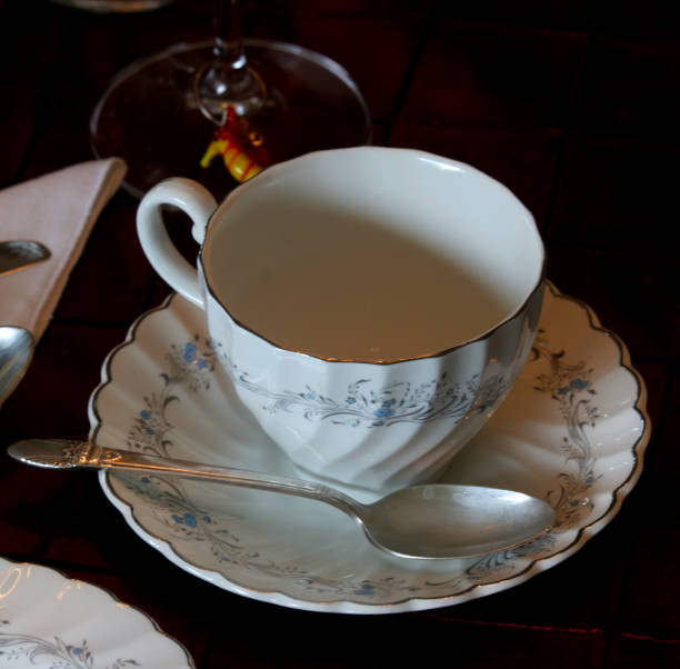 istock Elegant tea cup and saucer with teaspoon 1353287057