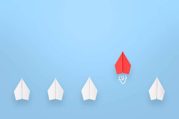 istock Change concepts with red paper airplane leading among white 1353290150