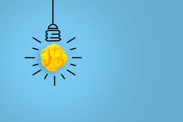 istock New Idea Concepts with Light Bulb Crumpled Paper on Blue Background 1353290180