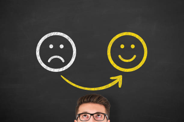 istock Unhappy and Happy over Human Head on Blackboard 1353290254