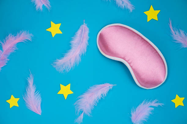istock Paper background with the feathers, stars and sleeping mask 1353290832