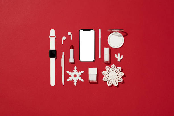 ホワイトクリスマスコンセプトフラットは、スマートフォンのモックアップで赤い背景に横たわって