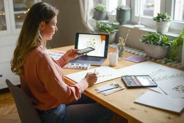 istock woman artist at work (with laptop) 1353291540