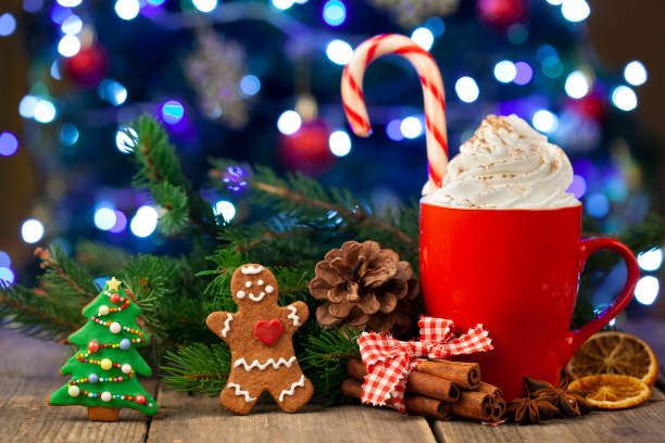 istock Christmas cappuccino and gingerbread cookies infront Christmas tree 1353292147