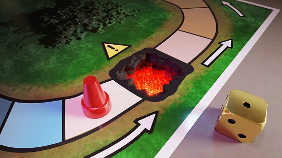 A board game with a hole on the next square with lava inside, and a die with its 1 side facing up