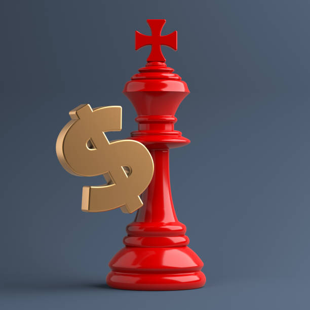 istock Red-colored king-chess piece and gold-colored Dollar symbol. 1353294583
