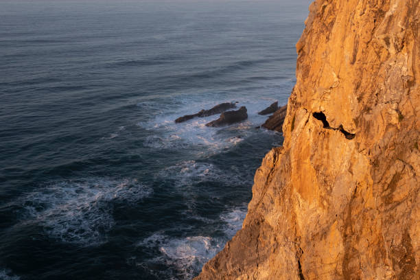 istock Cliffs and surf in the Atlantic Ocean at dusk, Portugal. 1353295617
