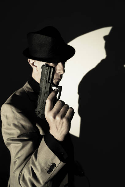 istock Spy thriller book cover design with man holding pistol gun. 1353297321