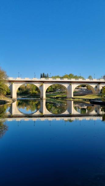istock Bridge reflection at the peaceful river in autumn 1353300992