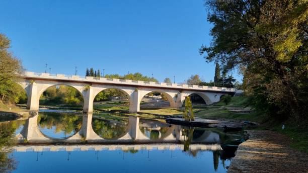 istock Bridge reflection at the peaceful river in autumn 1353301003