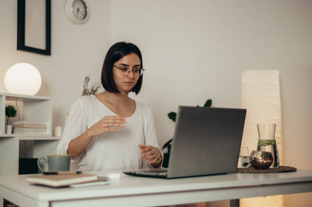 istock Woman using a laptop for an online meeting while working from home 1353305007