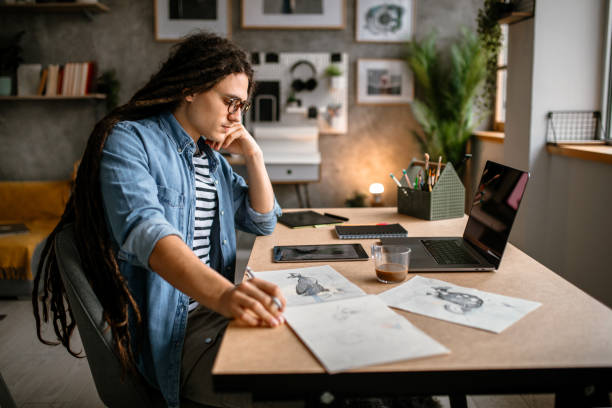 Artist drawing on paper in his creative studio