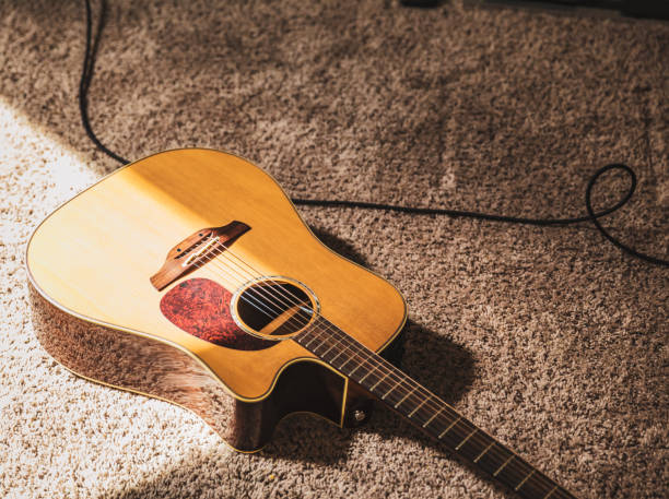 istock Expensive Acoustic Guitar on Carpet in Studio 1353308192