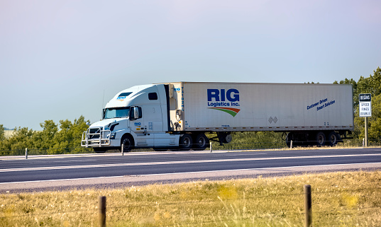A Rig Logistics Inc. truck hauling freight south on the Queen Elizabeth II Highway near Airdrie, Alberta, Canada. Taken on July 28, 2017