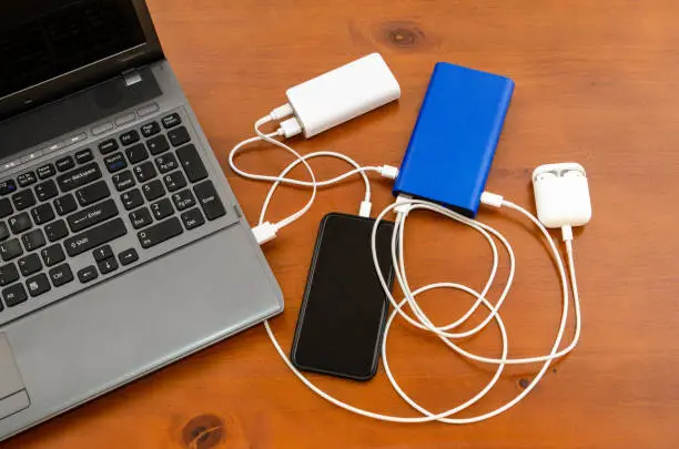 Photo of Charge sharing: recharging a laptop, a cellphones and an air pod set with couple power banks