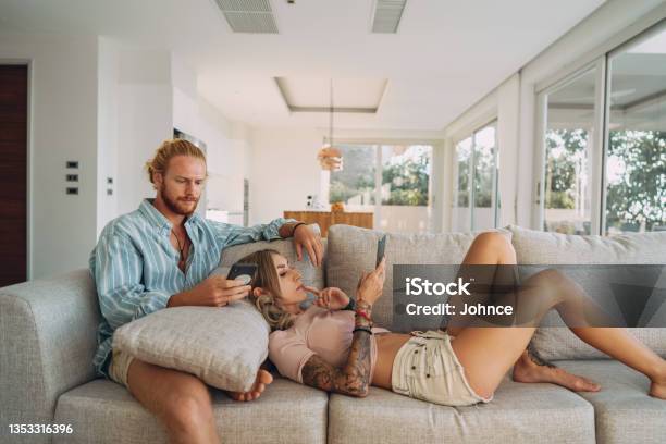 Couple Using Phones At Home Stock Photo - Download Image Now - Boredom, Real People, Social Media