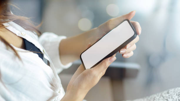 istock Side view, Woman holding smart phone. 1353320499