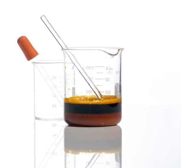 istock Closeup chemical ingredient on white laboratory table. Ferric Chloride Liquid with stirring rod in Beaker. Side View 1353322669