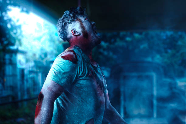 istock Scary zombie with blood and wound on his body walking 1353330604