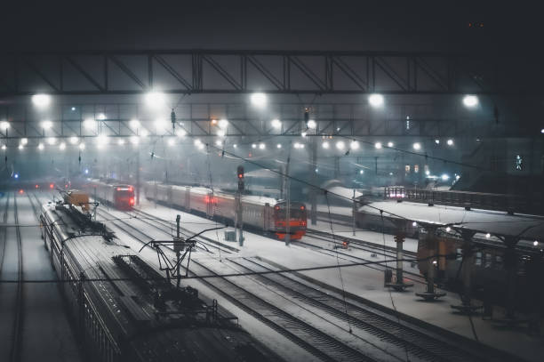 istock Defocused lights at the railway station at night. Selective focus, background 1353330627