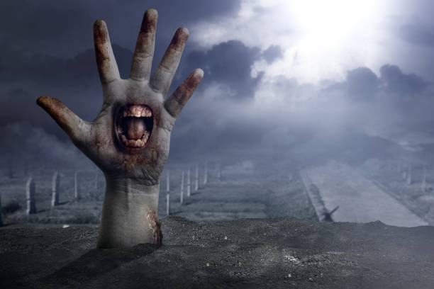 istock Zombie hands with a mouth on his palm raised 1353331306