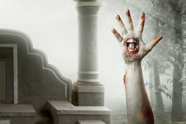 istock Zombie hands with a mouth on his palm raised 1353331317
