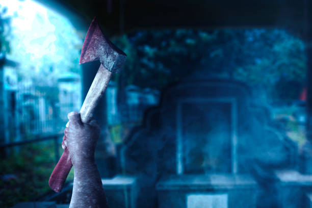 istock Zombie hands with wound holding an ax 1353331324