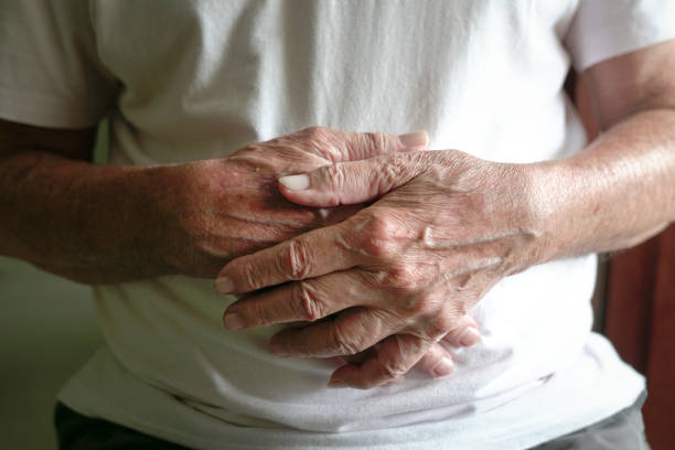 istock Close up view of senior man's hands clasped together. 1353332607