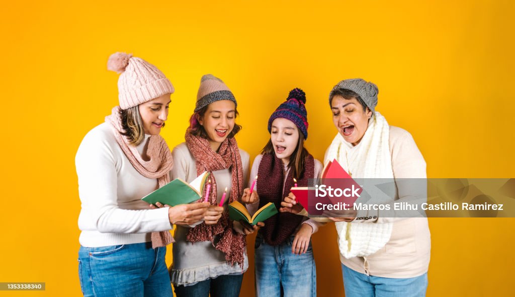 Posada Mexicana, Mexican family Singing carols at Christmas, three generations of women in Mexico Latin America Caroler Stock Photo