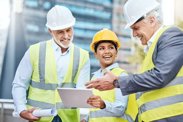 istock Shot of a group of businesspeople using a digital tablet while working at a construction site 1353341476