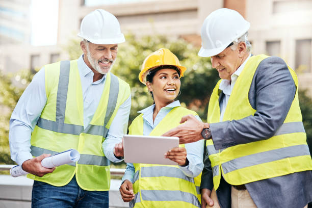 istock Shot of a group of businesspeople using a digital tablet while working at a construction site 1353341487