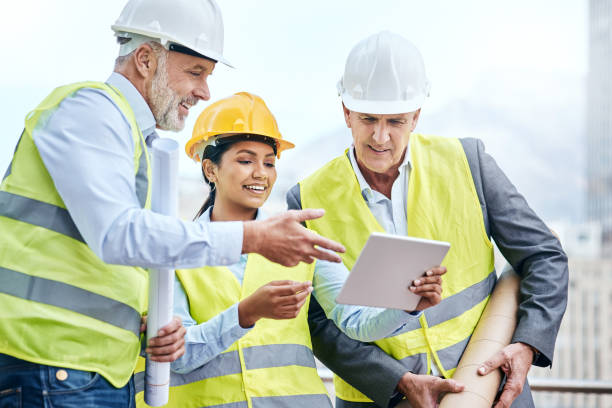 istock Shot of a group of businesspeople using a digital tablet while working at a construction site 1353341492