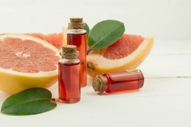 istock bottles with natural essence or grapefruit essential oil for self-care, aromatherapy, spa concept. 1353342218