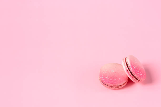 istock Pink macaroons on a pink background with a space for text. Sweet dessert for coffee and tea. Idea for postcards 1353347060