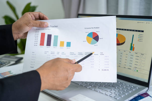 istock Asian accountant working and analyzing financial reports project accounting with chart graph and calculator in modern office, finance and business concept. 1353348170