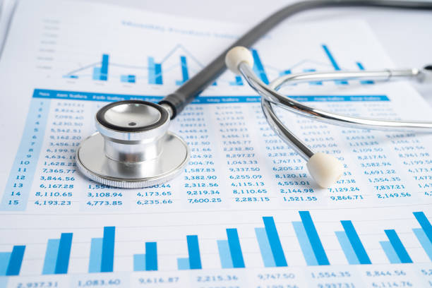 istock Stethoscope on spreadsheet paper, Finance, Account, Statistics, Investment, Analytic research data economy spreadsheet and Business company concept. 1353348176