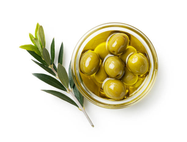 Olive nuts and olive oil in a bowl on a white background. View from directly above