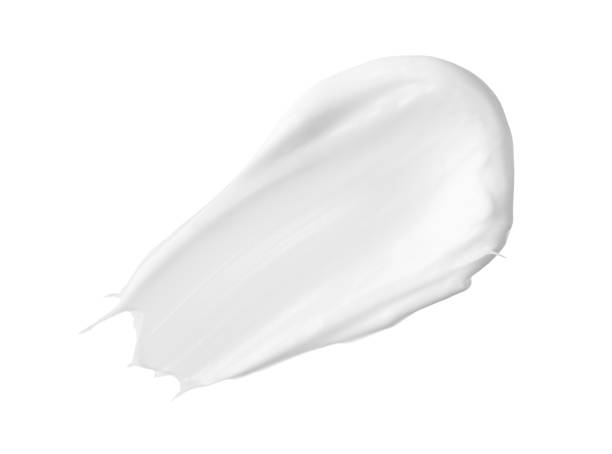 白いメイクアップクリームは、白い背景にスイープ。bb, cc クリーム テクスチャー - クレンジング剤 ストックフォトと画像