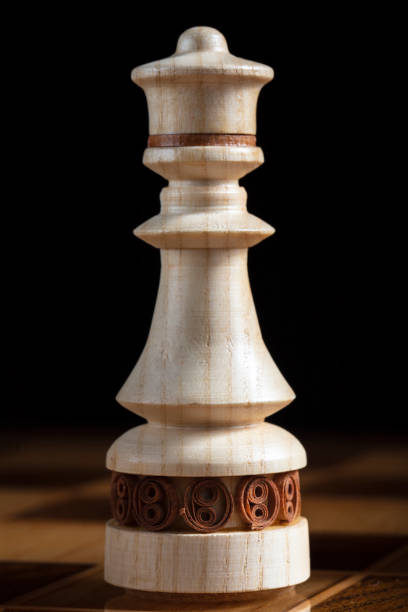 istock Chess king on a black background. A puzzle game with tricky combinations that requires planning and thinking. 1353349524