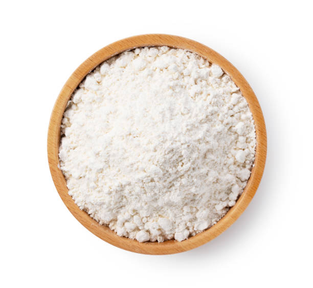 istock Flour in a wooden bowl set against a white background 1353350546