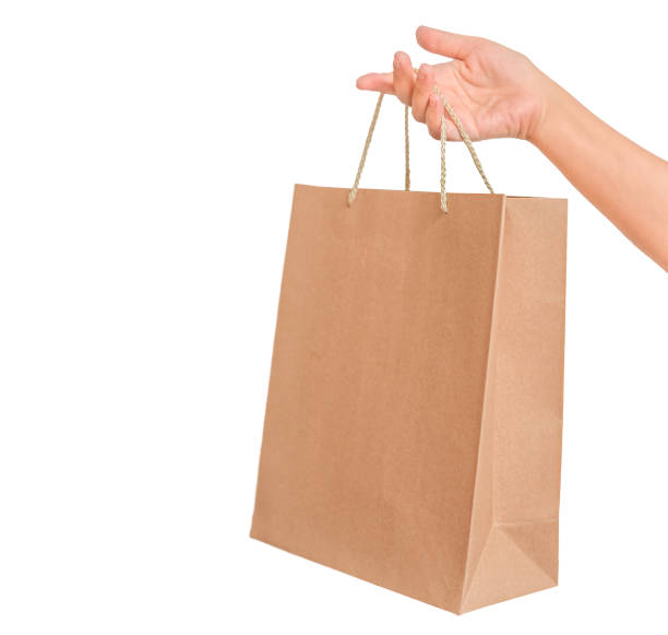 istock Cardboard shopping bag in female hand 1353350554
