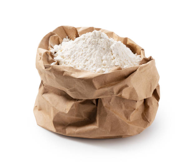 istock Flour in a paper bag on a white background 1353350563
