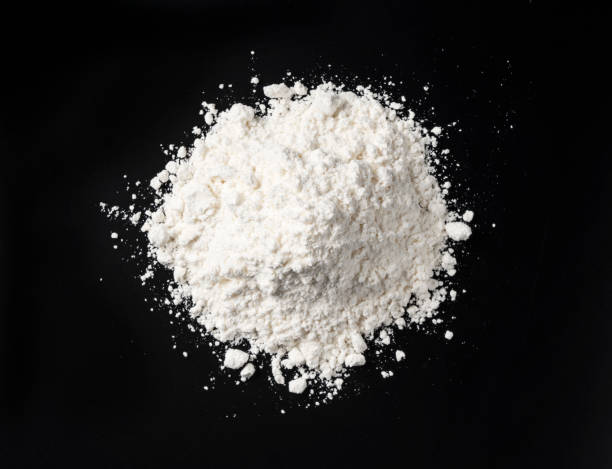 White flour smeared on black table White flour on black background, dough ingredients, top view flour stock pictures, royalty-free photos & images