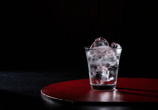 istock Shochu placed on a red tray against a black background. 1353351902