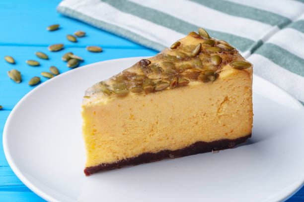 istock Slice of cheesecake with nuts on plate 1353354566