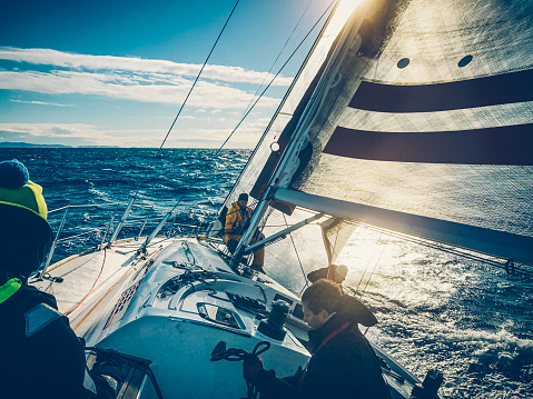 A sailing crew (man/woman) on a sailboat during a regatta. Crew members on the sailboat Model released, event Regatta Jabuka Property released.