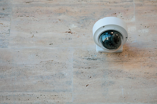 Details with a CCTV camera on a wall inside a building.
